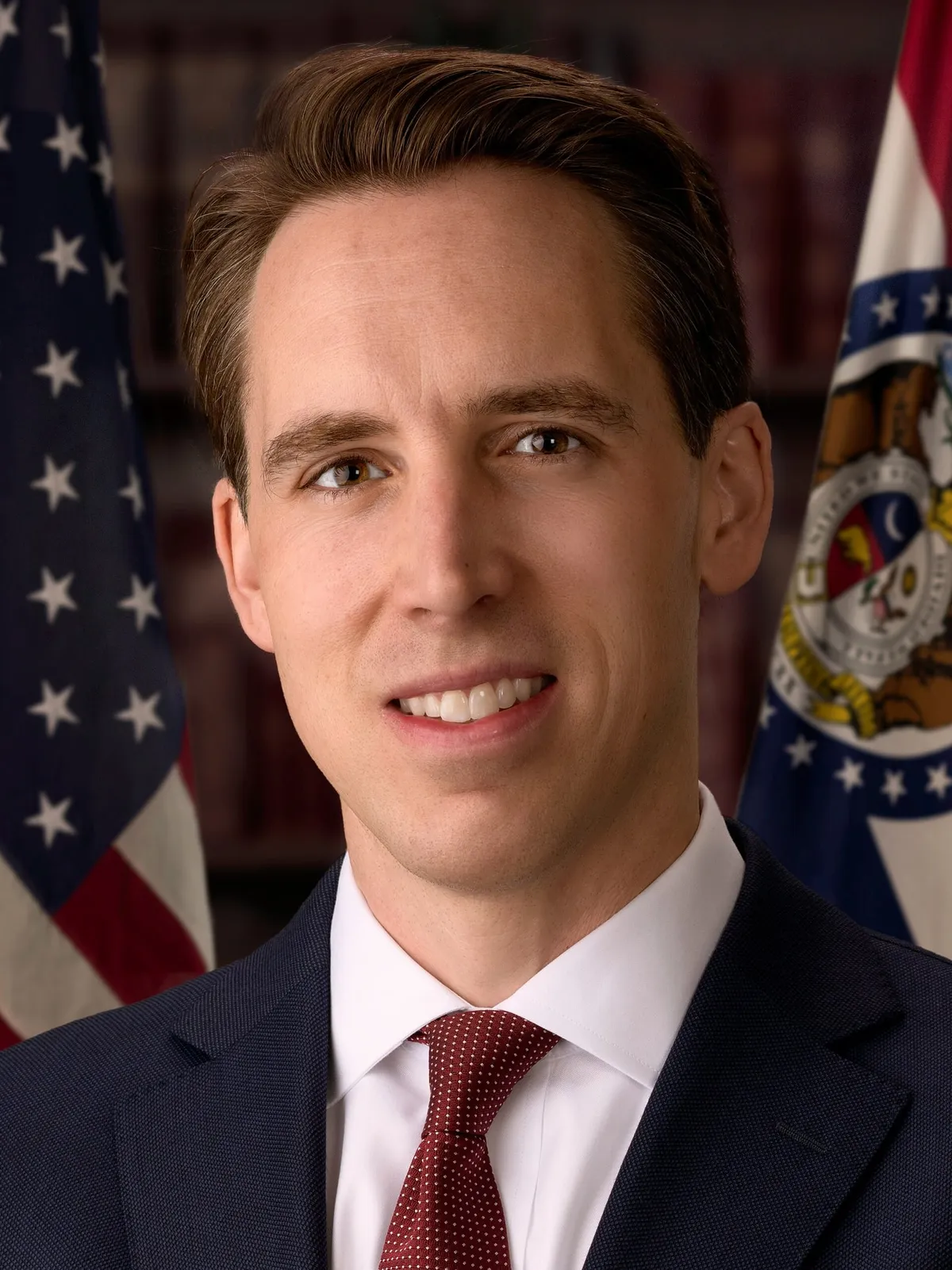 Official Senate portrait of Josh Hawley in front of flags